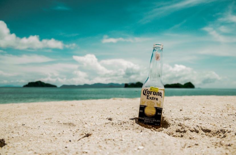 bottle of Corona beer on the sand by the beach