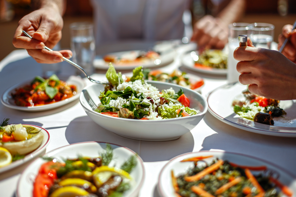 a couple eating healthy dishes on a table