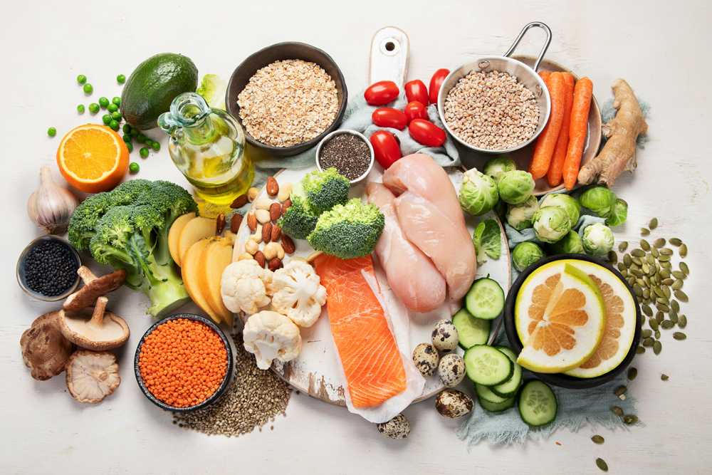 Healthy food selection on white background. Detox and clean diet concept. Foods high in vitamins, minerals and antioxidants. Anti age foods. Top view